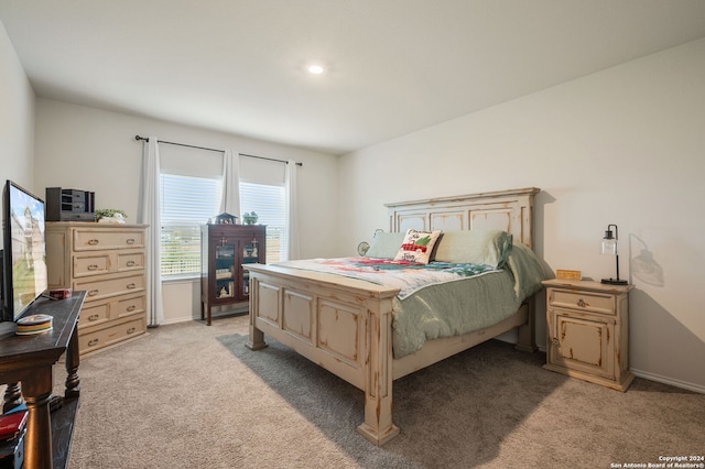 bedroom featuring light carpet