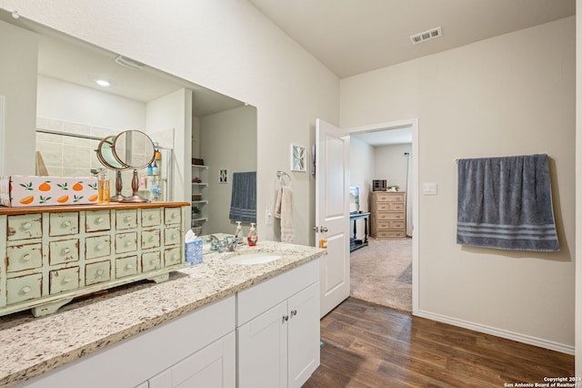 bathroom with vanity and hardwood / wood-style flooring