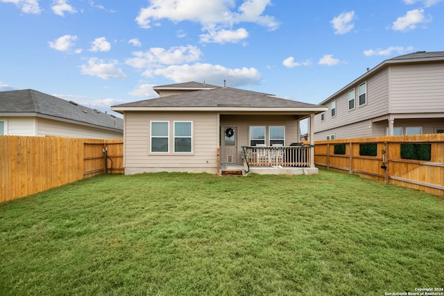 rear view of property with a yard