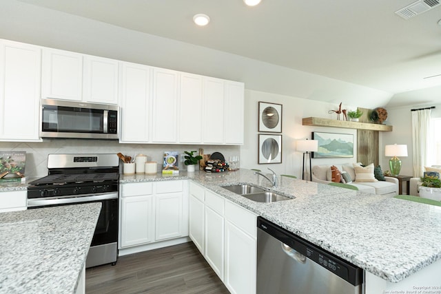 kitchen featuring appliances with stainless steel finishes, decorative backsplash, sink, and white cabinets