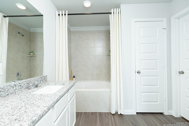 bathroom featuring hardwood / wood-style floors, shower / tub combo with curtain, and vanity