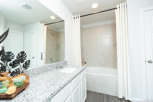 bathroom featuring vanity, shower / bathtub combination with curtain, and wood-type flooring