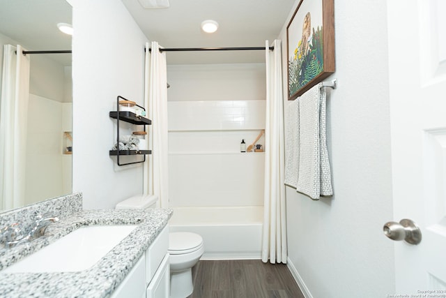 full bathroom with vanity, shower / tub combo, toilet, and hardwood / wood-style floors