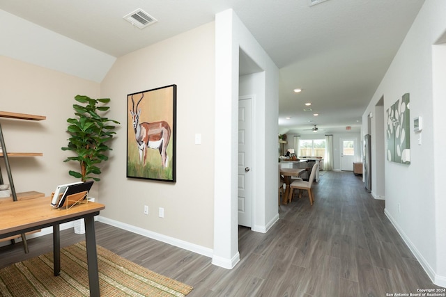 home office with lofted ceiling and dark hardwood / wood-style flooring