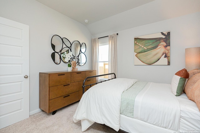 carpeted bedroom featuring lofted ceiling