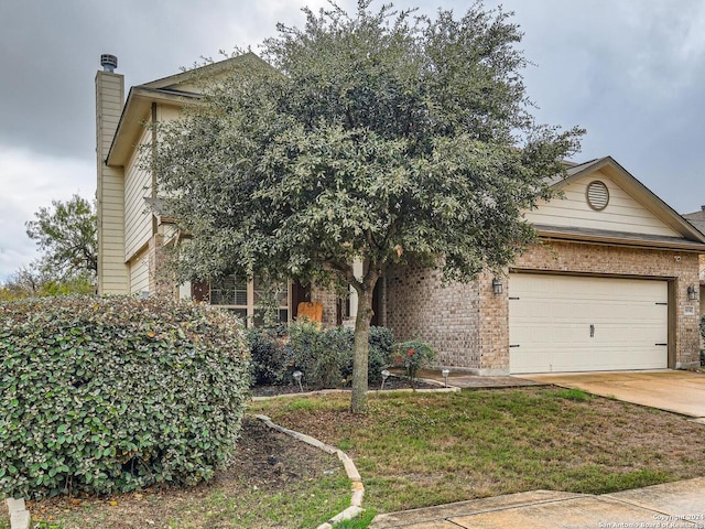 view of property hidden behind natural elements featuring a garage