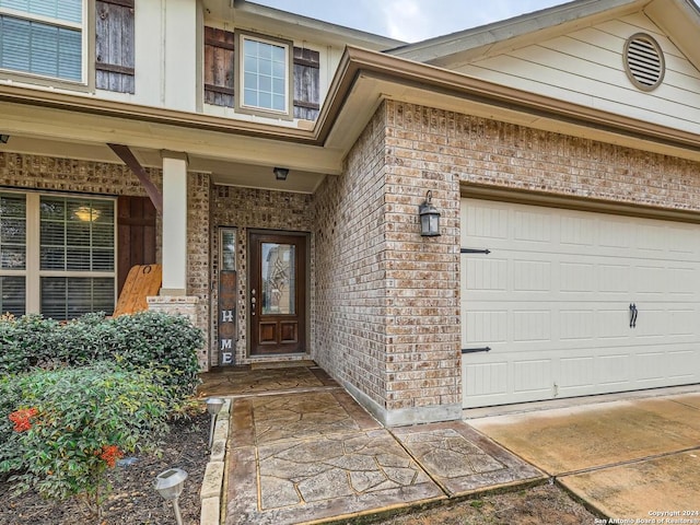 view of exterior entry with a garage