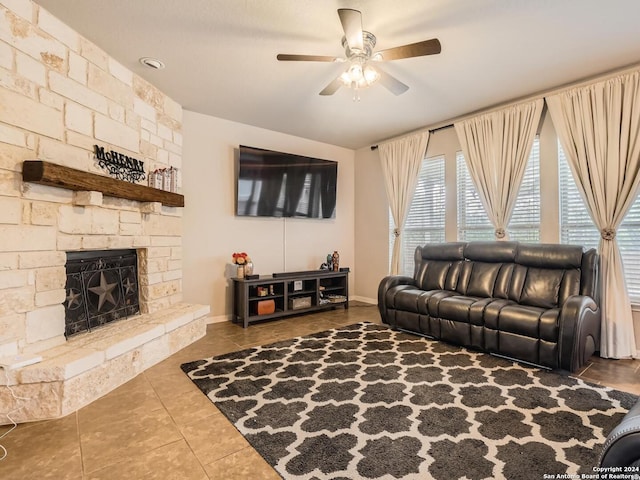 living room with a fireplace, tile patterned floors, and ceiling fan