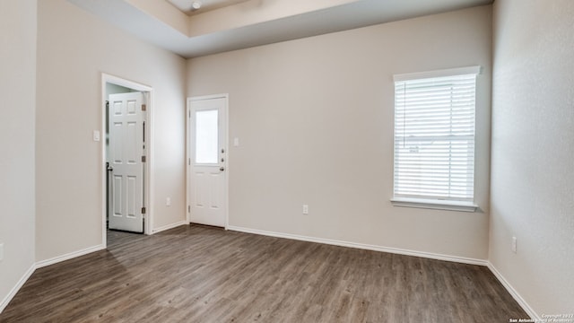 unfurnished room featuring dark wood-type flooring