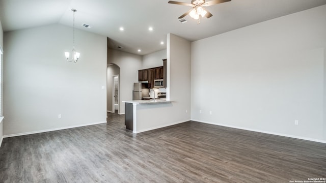 unfurnished living room featuring sink, ceiling fan with notable chandelier, dark wood-type flooring, and vaulted ceiling