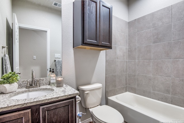 full bathroom with vanity, toilet, and tiled shower / bath combo