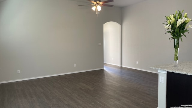 unfurnished living room with ceiling fan and dark hardwood / wood-style floors