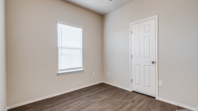 spare room with dark hardwood / wood-style flooring