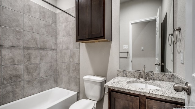 full bathroom featuring vanity, tiled shower / bath combo, and toilet