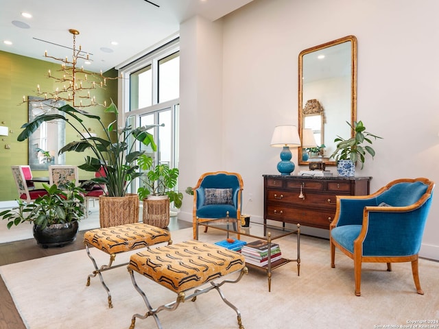 living area featuring light hardwood / wood-style flooring and a notable chandelier