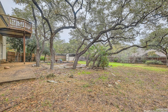 view of yard with a storage unit and a wooden deck