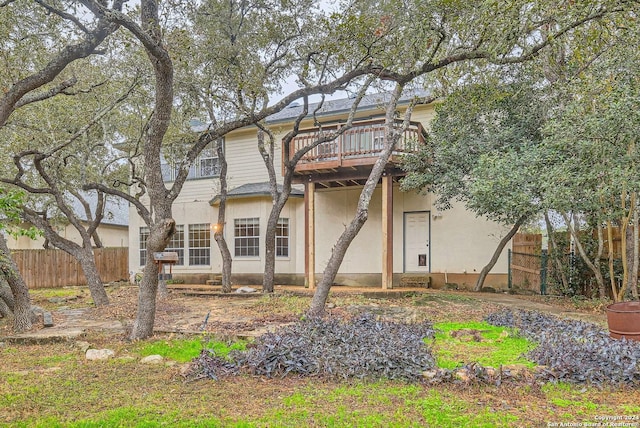 rear view of property featuring a balcony