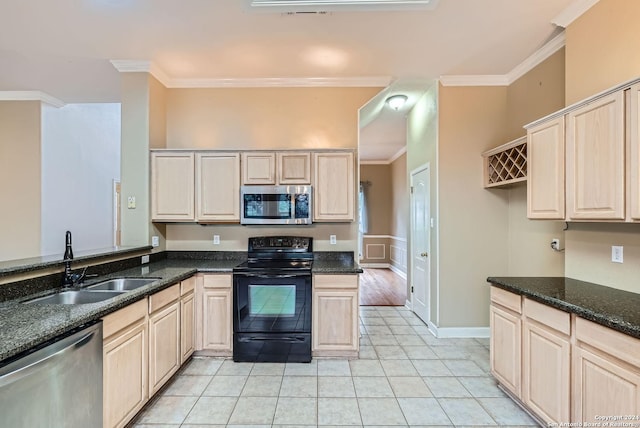 kitchen featuring light tile patterned floors, stainless steel appliances, ornamental molding, and sink