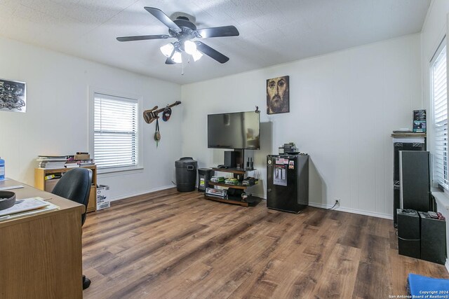 home office featuring ceiling fan, plenty of natural light, and dark wood-type flooring