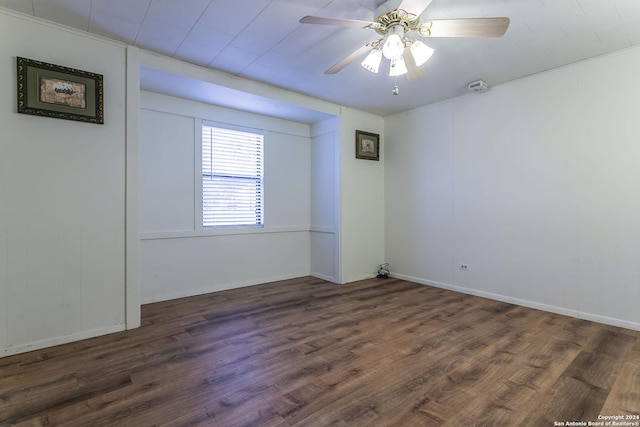 empty room featuring ceiling fan and dark hardwood / wood-style flooring