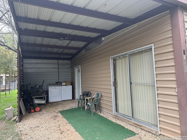 exterior space featuring independent washer and dryer and a carport