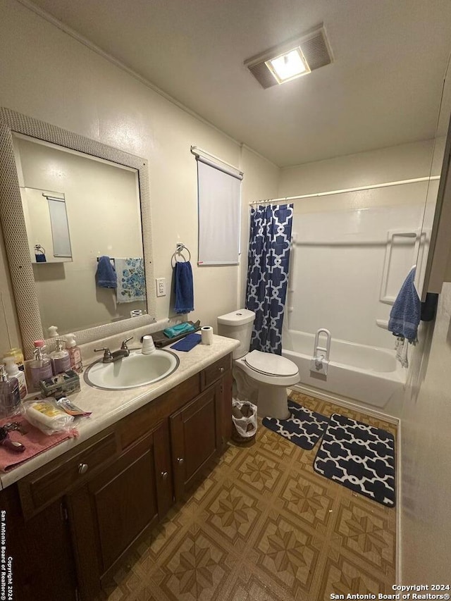 full bathroom with vanity, shower / bath combo, and toilet