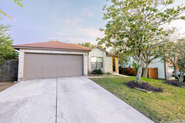 single story home with a garage and a front yard