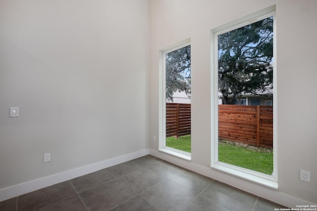 doorway featuring dark tile patterned floors