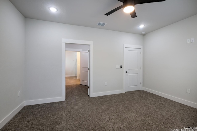 carpeted spare room with ceiling fan