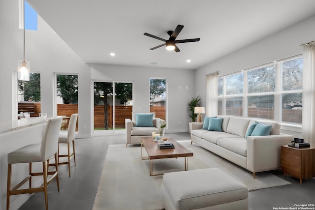 living room with ceiling fan and high vaulted ceiling