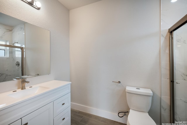 bathroom with vanity, toilet, and walk in shower