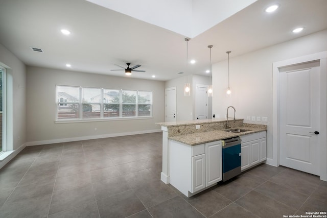 kitchen featuring light stone counters, ceiling fan, sink, decorative light fixtures, and white cabinets