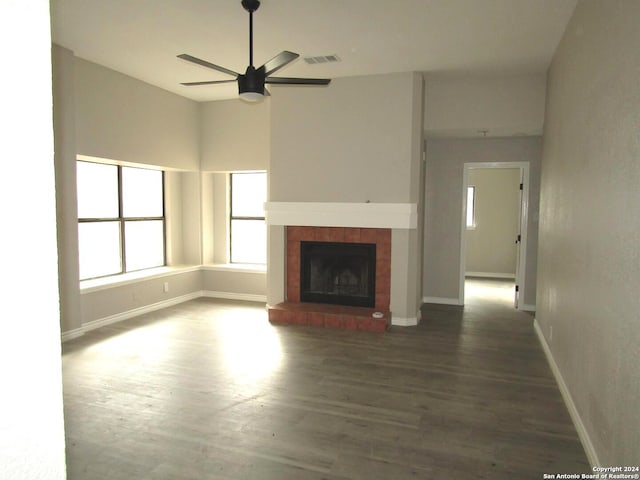 unfurnished living room featuring ceiling fan and dark hardwood / wood-style floors