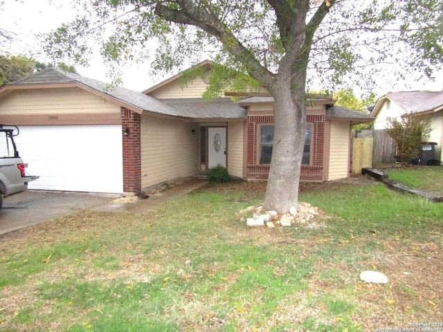 single story home with a garage and a front yard