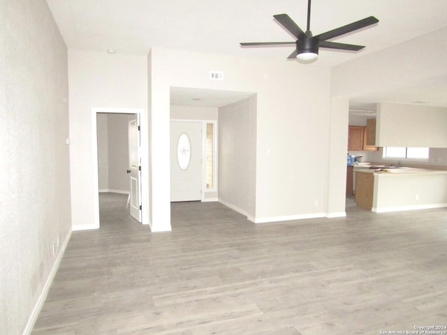 empty room featuring ceiling fan and light hardwood / wood-style floors