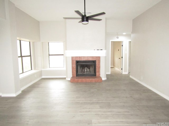 unfurnished living room featuring a fireplace, ceiling fan, and hardwood / wood-style floors