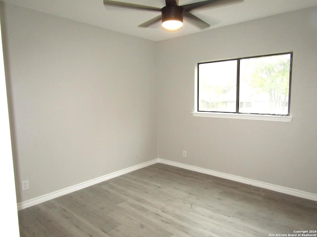 spare room with hardwood / wood-style flooring and ceiling fan