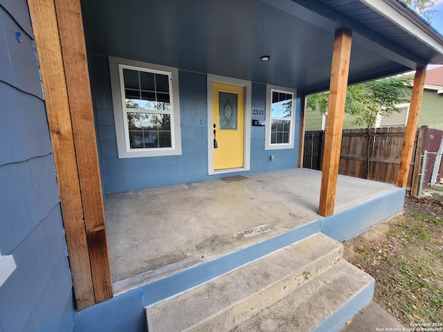 view of exterior entry with a porch