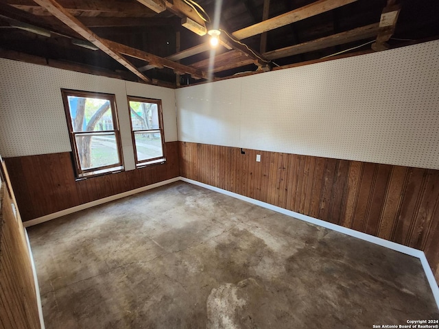 basement featuring wooden walls