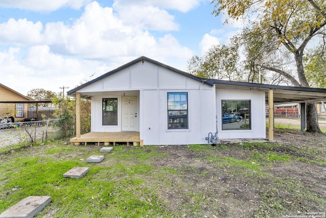 rear view of property featuring a yard