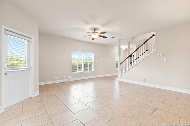 interior space featuring light tile patterned floors and ceiling fan