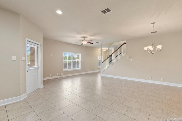 unfurnished living room with light tile patterned floors and ceiling fan with notable chandelier