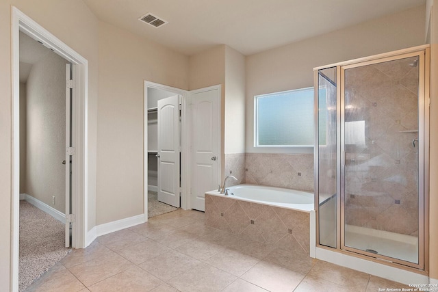 bathroom with tile patterned flooring and independent shower and bath