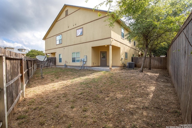 rear view of property with a patio area and central AC