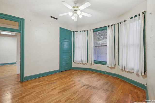 empty room with ceiling fan and wood-type flooring