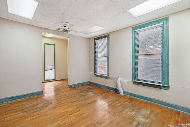 spare room featuring hardwood / wood-style floors and a paneled ceiling