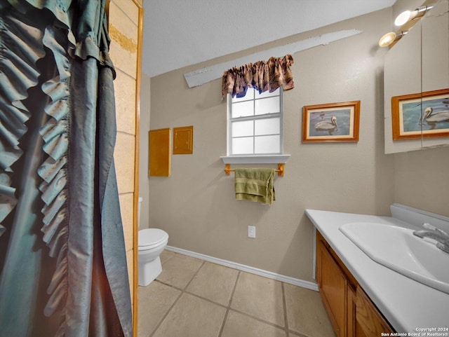 bathroom featuring toilet, vanity, and tile patterned floors