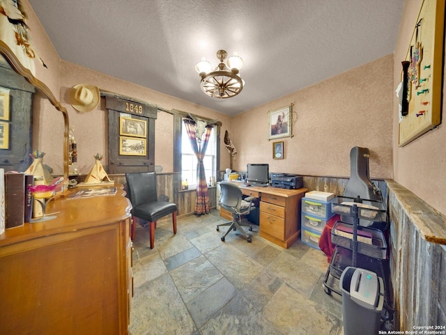 home office with a chandelier and a textured ceiling