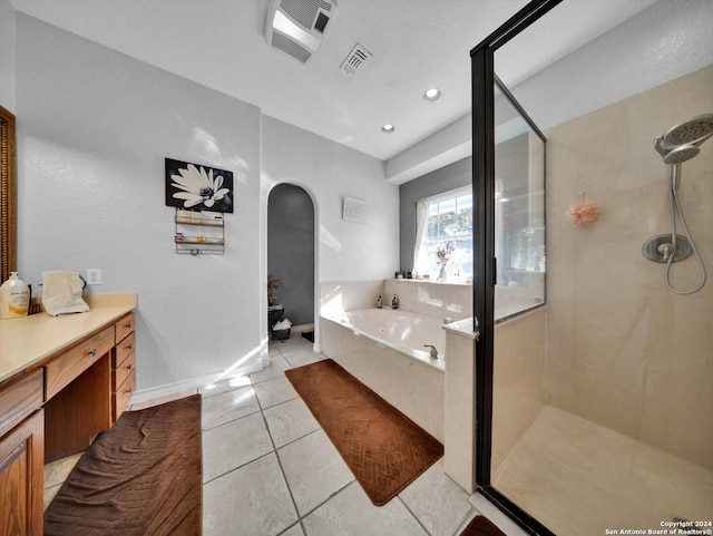 bathroom featuring tile patterned flooring, vanity, and independent shower and bath