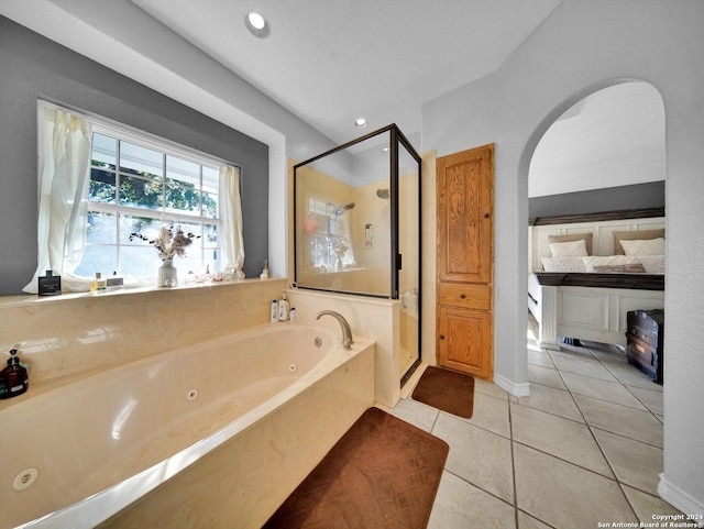 bathroom with tile patterned flooring and independent shower and bath